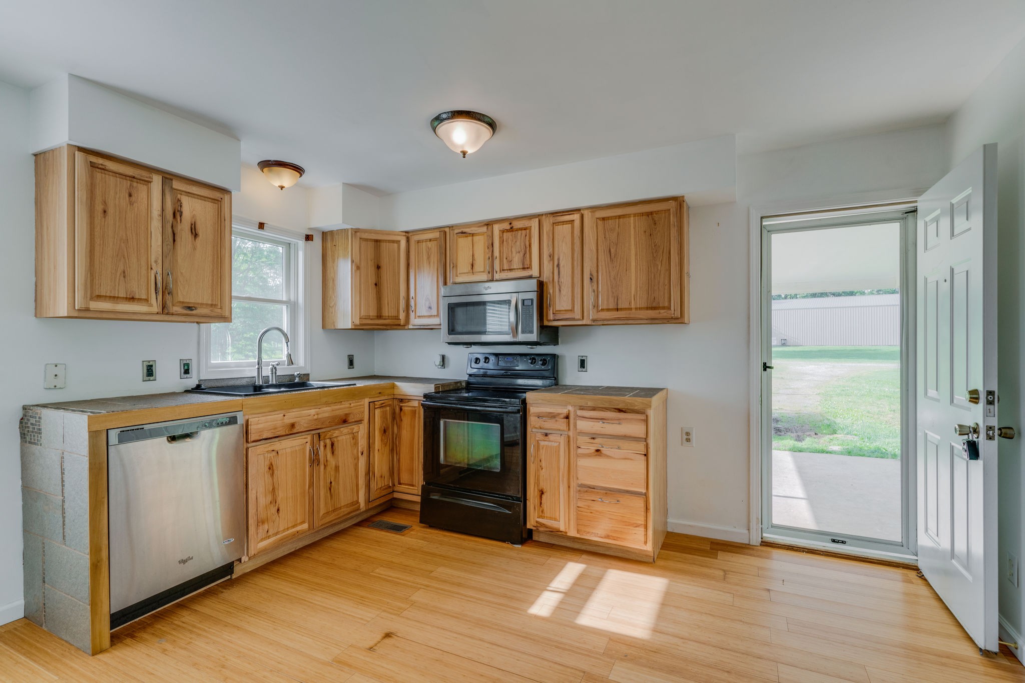 4614 Woodrow Wilson Road Springfield, TN 37172 - Photo 8 of 29 a kitchen with stainless steel appliances granite countertop a stove a sink and a refrigerator