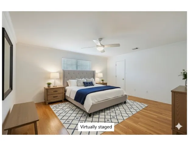 a bedroom with a bed and a night stand