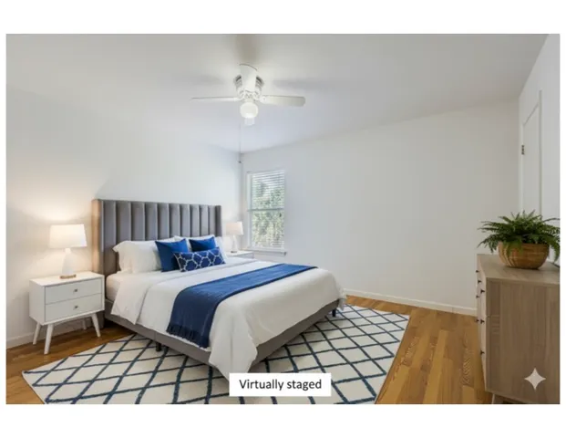 a bedroom with a bed and a potted plant