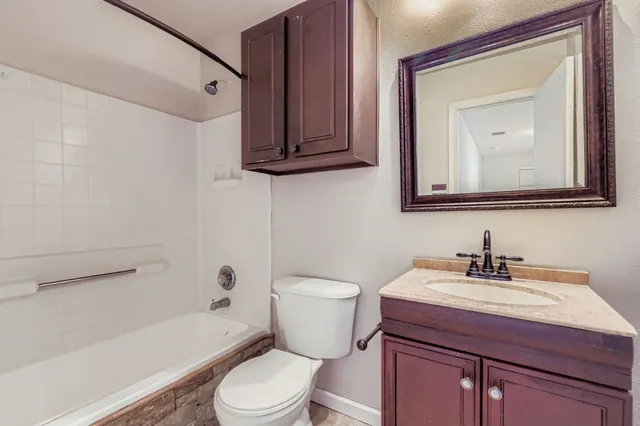 a bathroom with a toilet a sink and bathtub