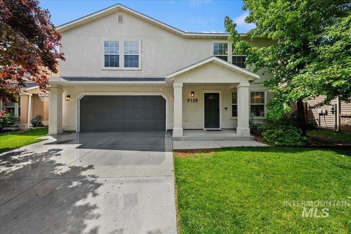 9159 West Rustica Drive Boise, ID 83709 - Photo 1 of 1 Traditional home with stucco siding, an attached garage, and a front lawn