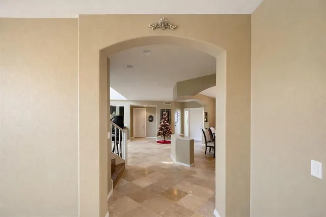 a view of a hallway with wooden shelves