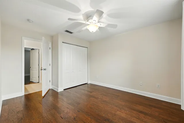 a view of a room with wooden floor and closet
