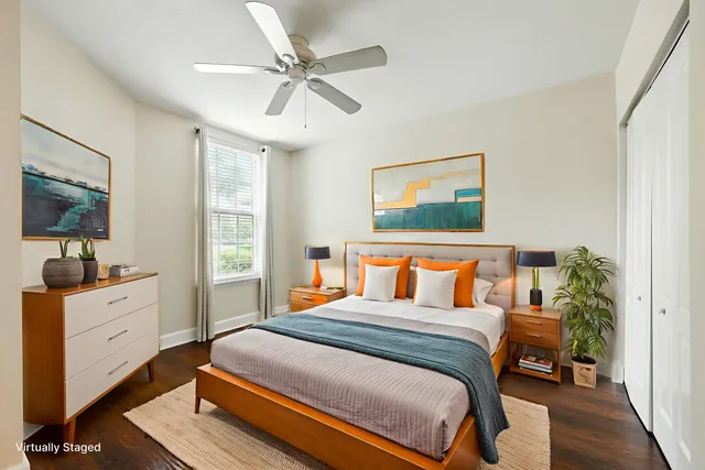 a bedroom with a large bed and a flat tv screen on dresser