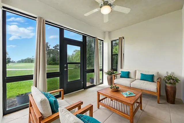 a living room with furniture and a large window