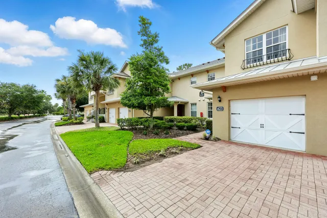 a front view of a house with a yard and a garage