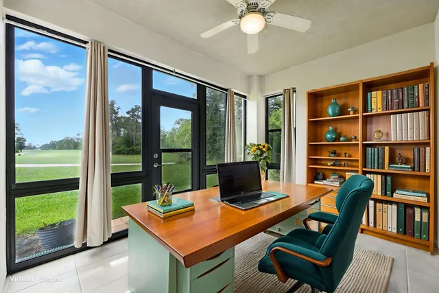 a room with furniture pool table and a floor to ceiling window