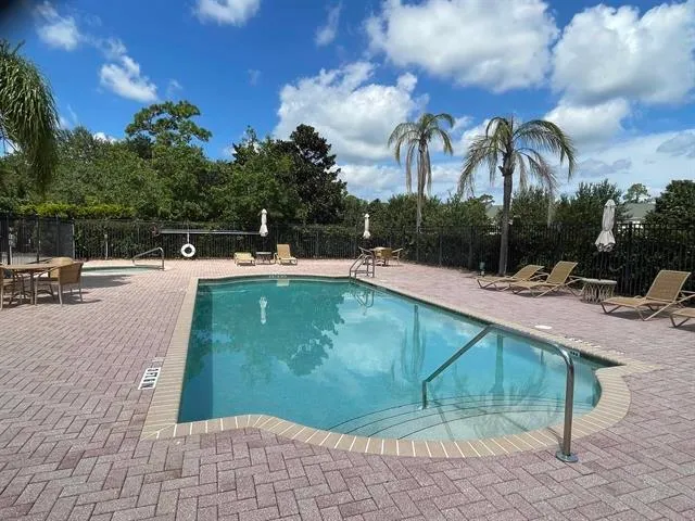 a view of a swimming pool with a patio