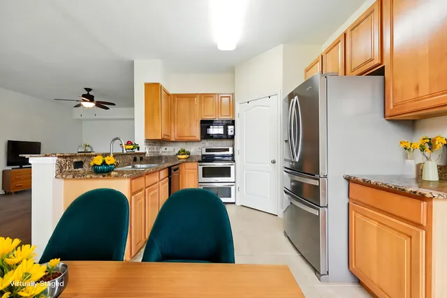 a kitchen with stainless steel appliances a refrigerator stove microwave and sink