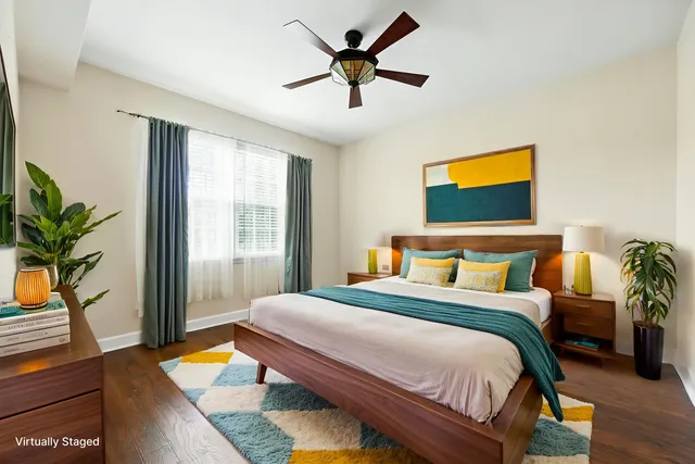 a bedroom with a bed and a potted plant