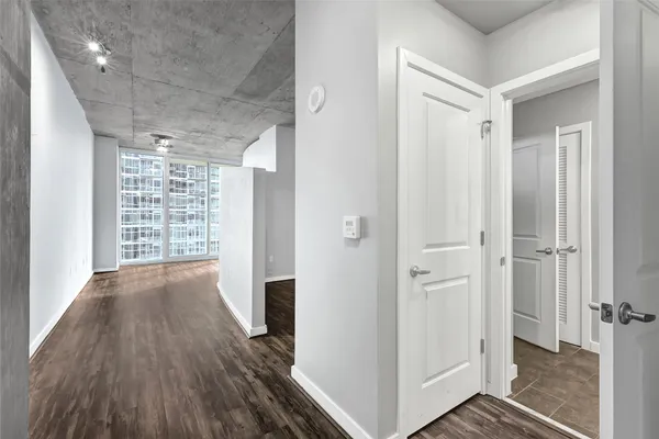 a view of a hallway with wooden floor