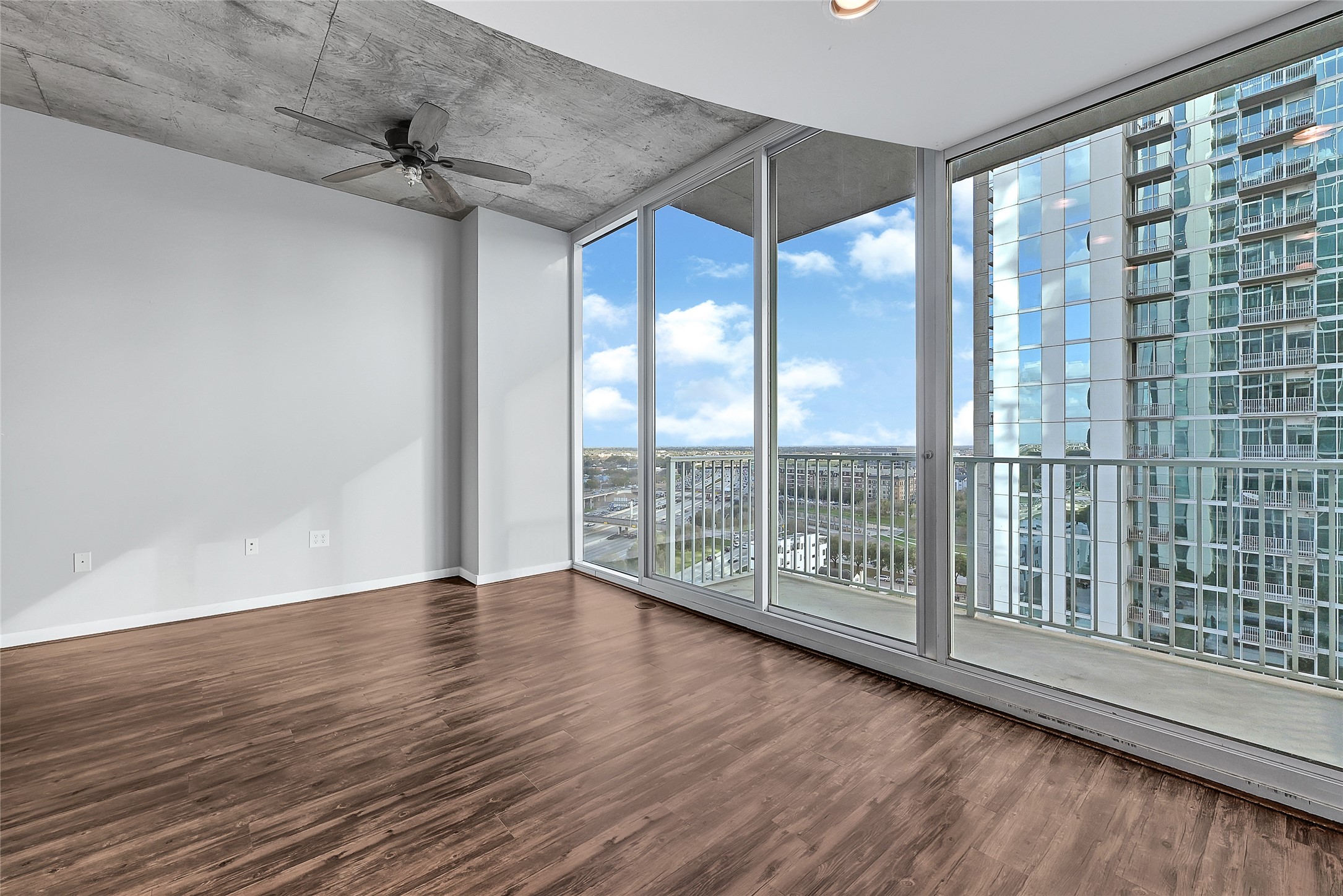 5925 Almeda Road, Unit 11306 Houston, TX 77004 - Photo 5 of 32 a view of an empty room with wooden floor and a window