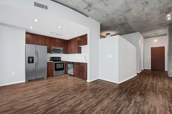 a kitchen with granite countertop a sink and a stove top oven