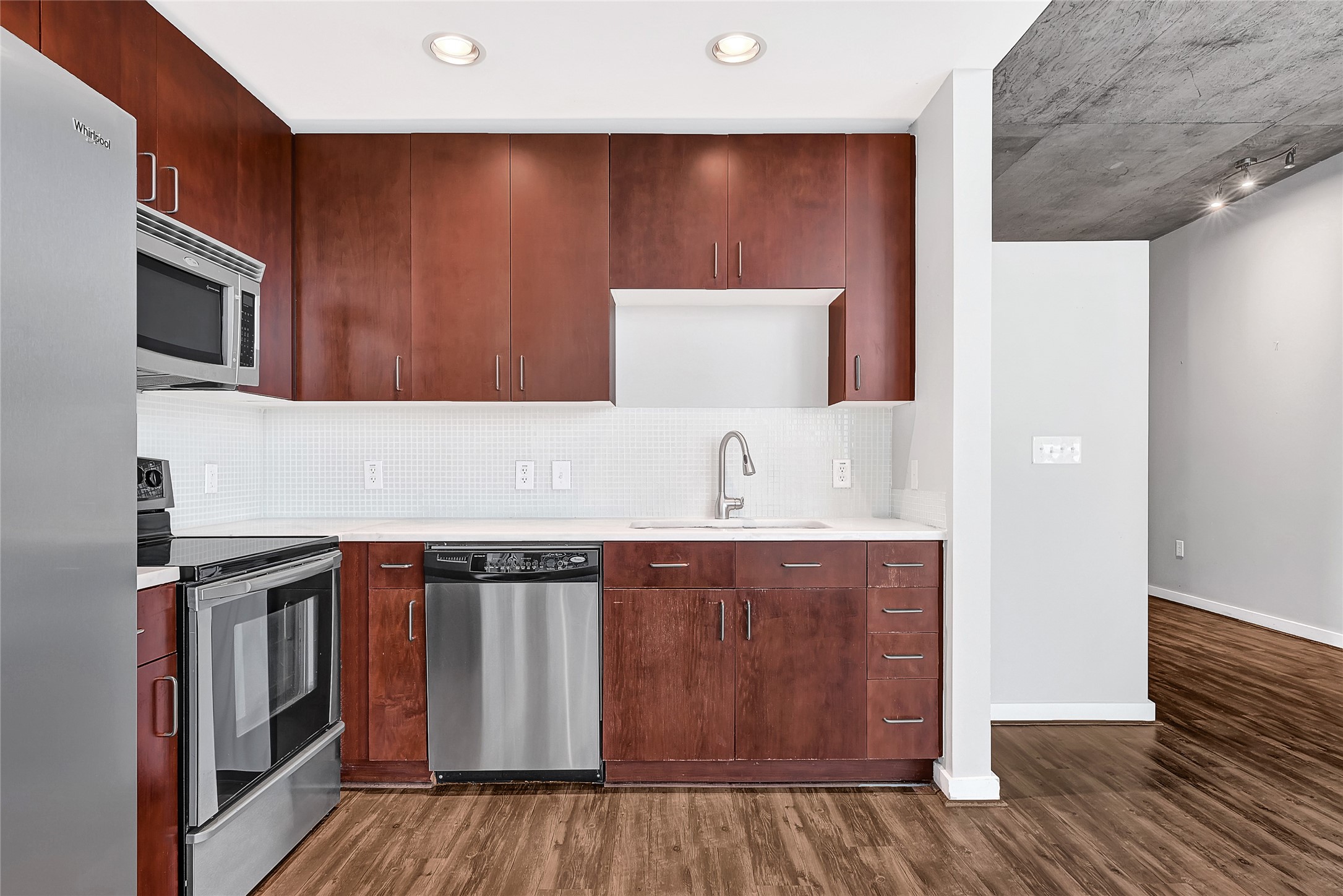 5925 Almeda Road, Unit 11306 Houston, TX 77004 - Photo 9 of 32 a view of cabinets with stainless steel appliances granite countertop a sink and a stove