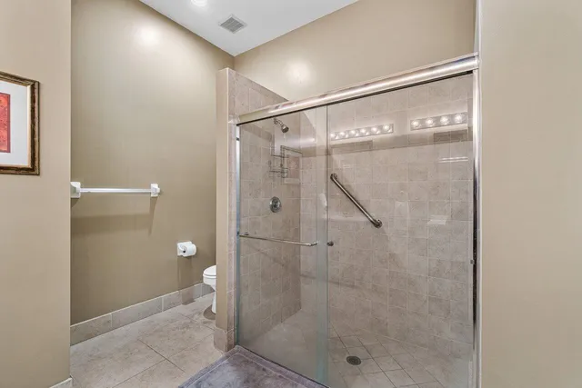 a bathroom with a glass shower door