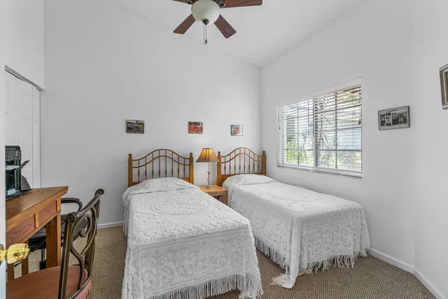 a bedroom with two beds and a window