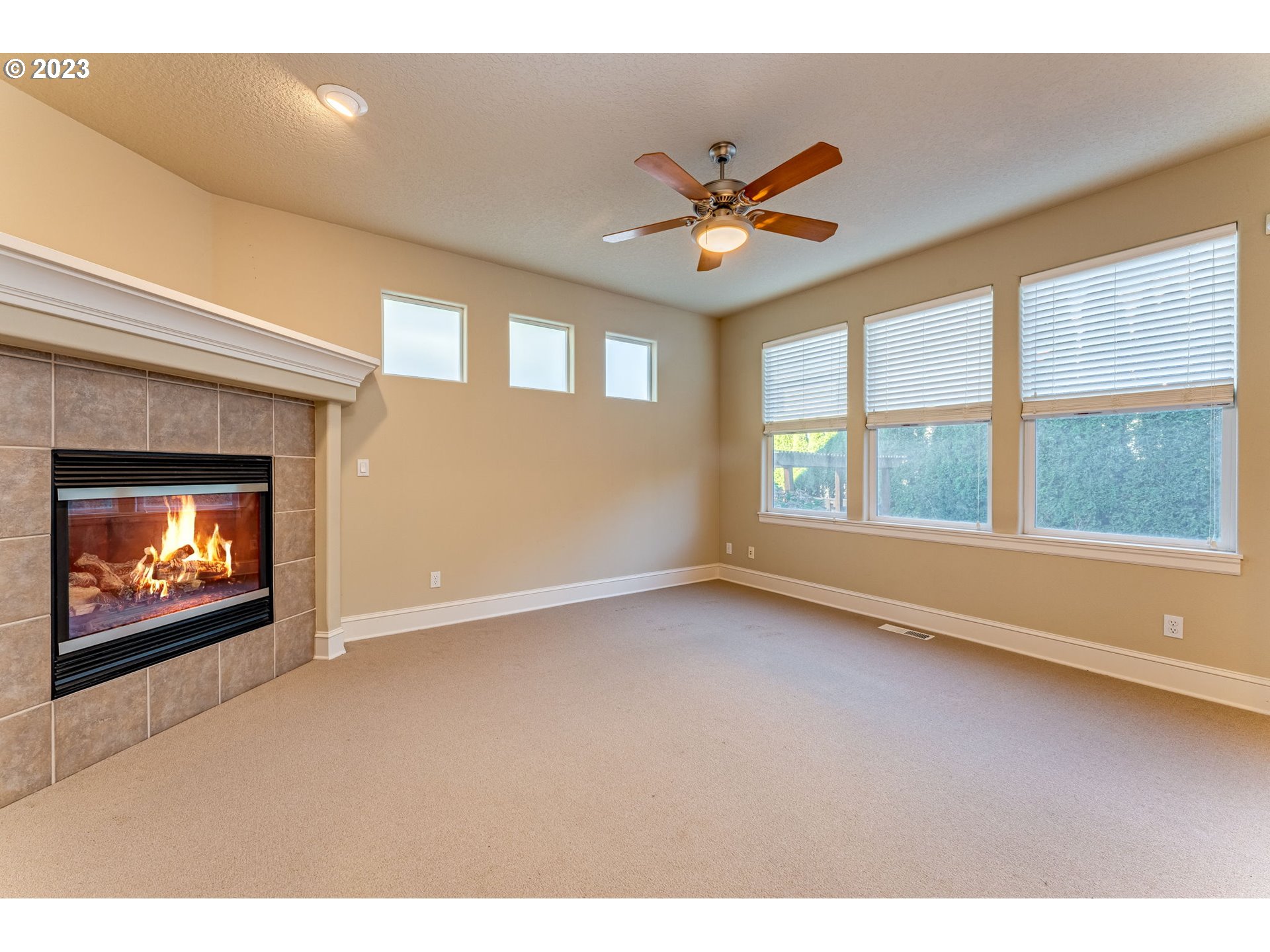 12581 Northwest Forest Spring Lane Portland, OR 97229 - Photo 12 of 48 a view of an empty room with a window and fireplace