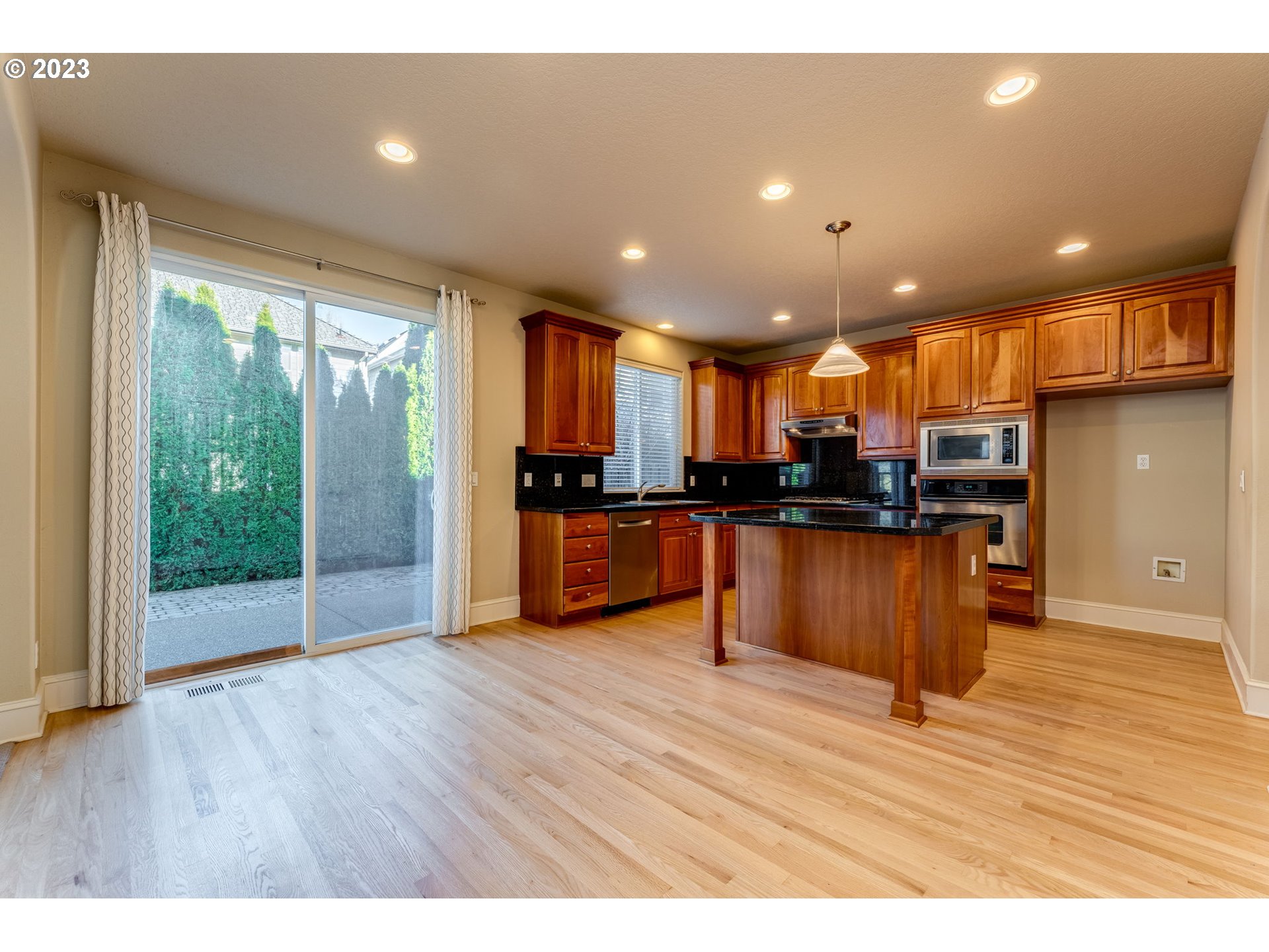 12581 Northwest Forest Spring Lane Portland, OR 97229 - Photo 17 of 48 a view of kitchen with stainless steel appliances granite countertop a stove top oven