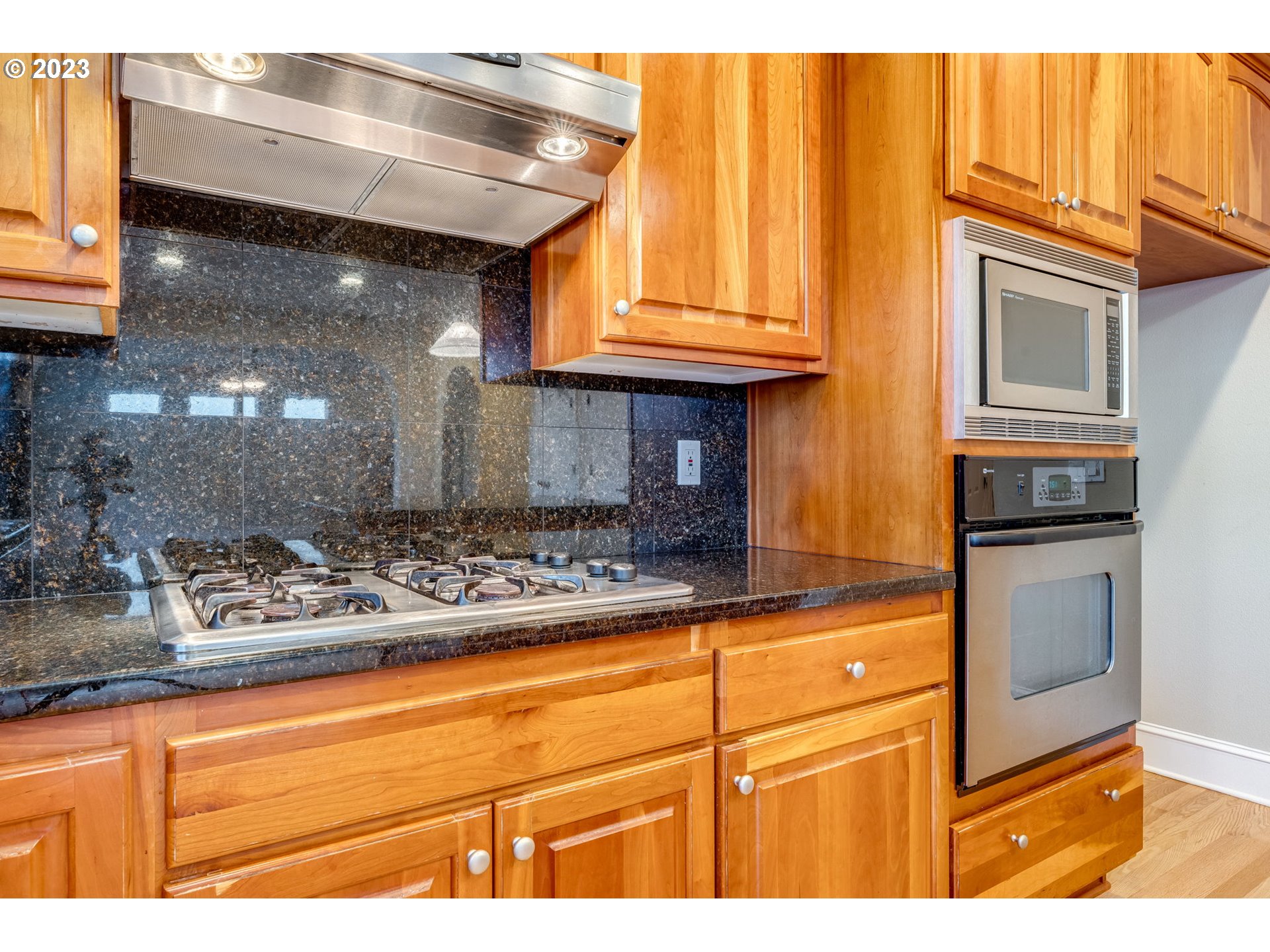 12581 Northwest Forest Spring Lane Portland, OR 97229 - Photo 19 of 48 a kitchen with stainless steel appliances granite countertop a sink and cabinets