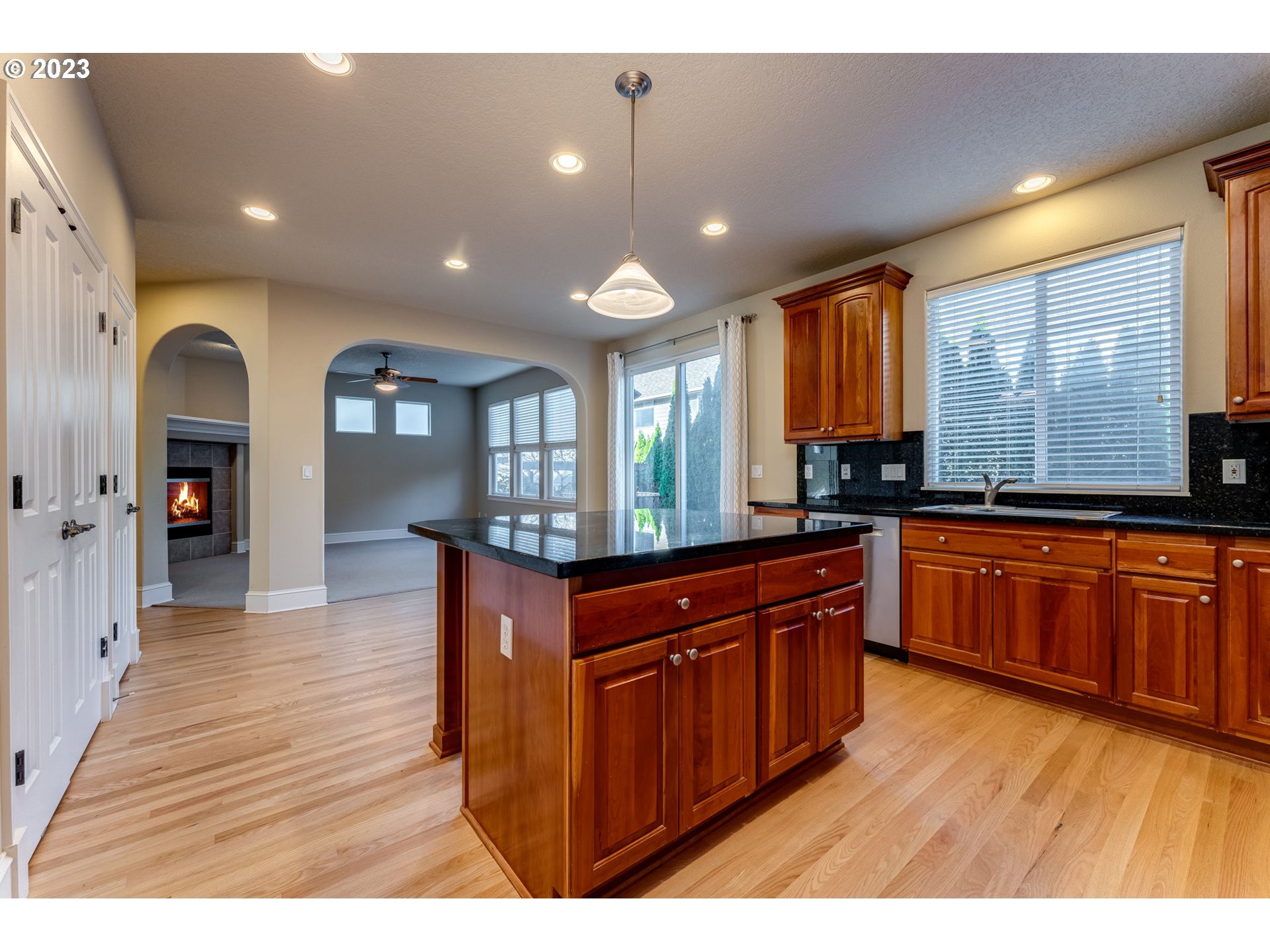12581 Northwest Forest Spring Lane Portland, OR 97229 - Photo 21 of 48 a kitchen with stainless steel appliances granite countertop wooden cabinets a stove a sink and a wooden floors
