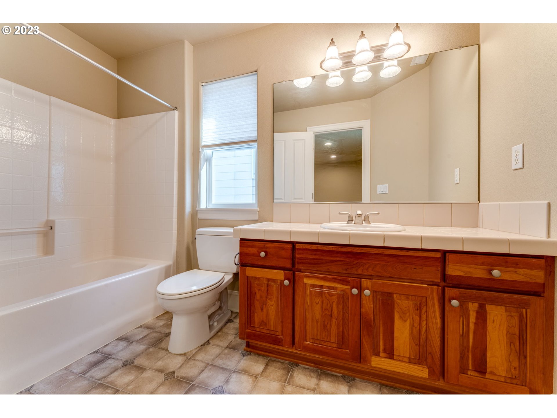 12581 Northwest Forest Spring Lane Portland, OR 97229 - Photo 33 of 48 a bathroom with a sink a toilet a mirror and bathtub