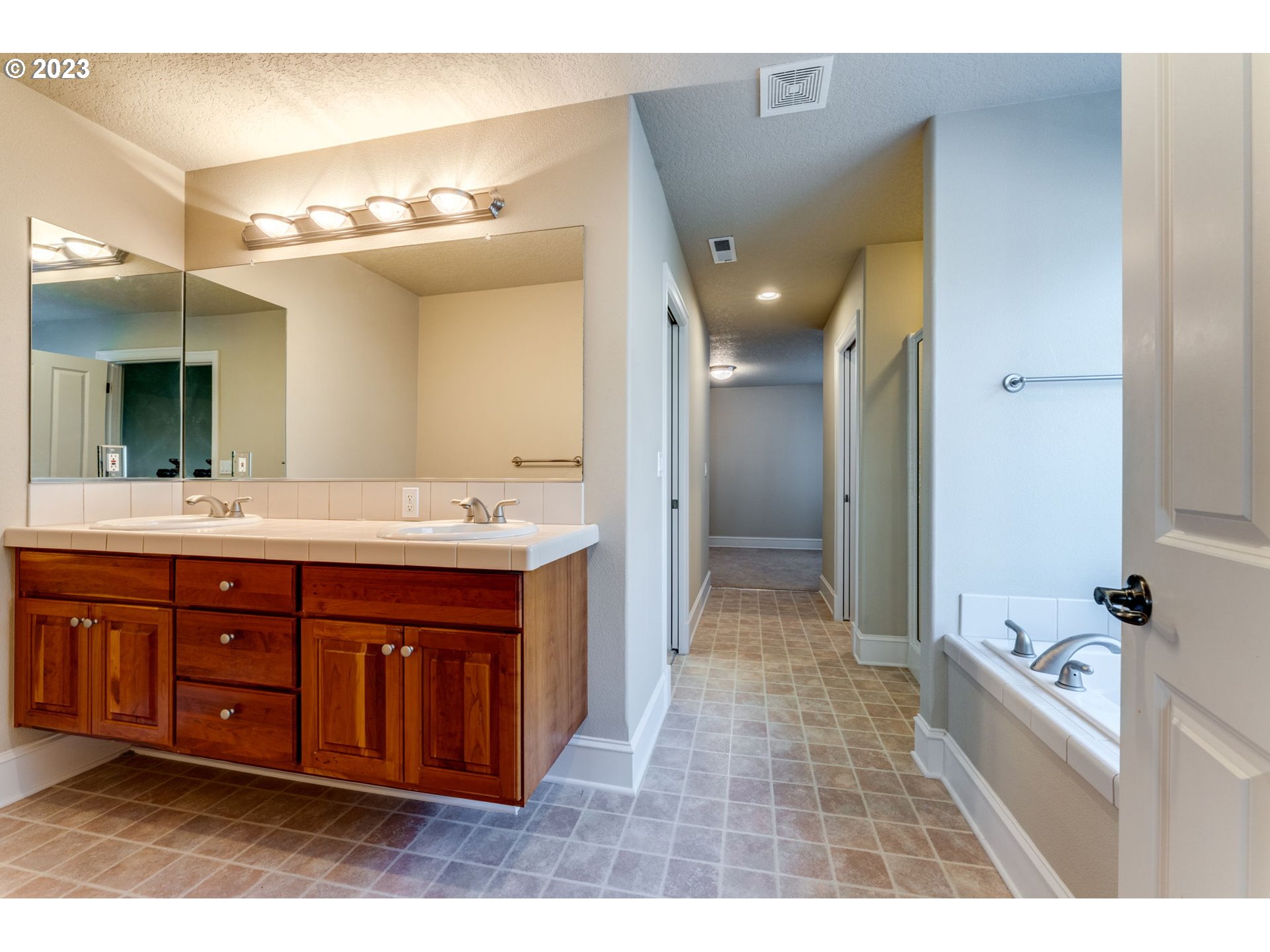 12581 Northwest Forest Spring Lane Portland, OR 97229 - Photo 36 of 48 a bathroom with a tub sink and mirror