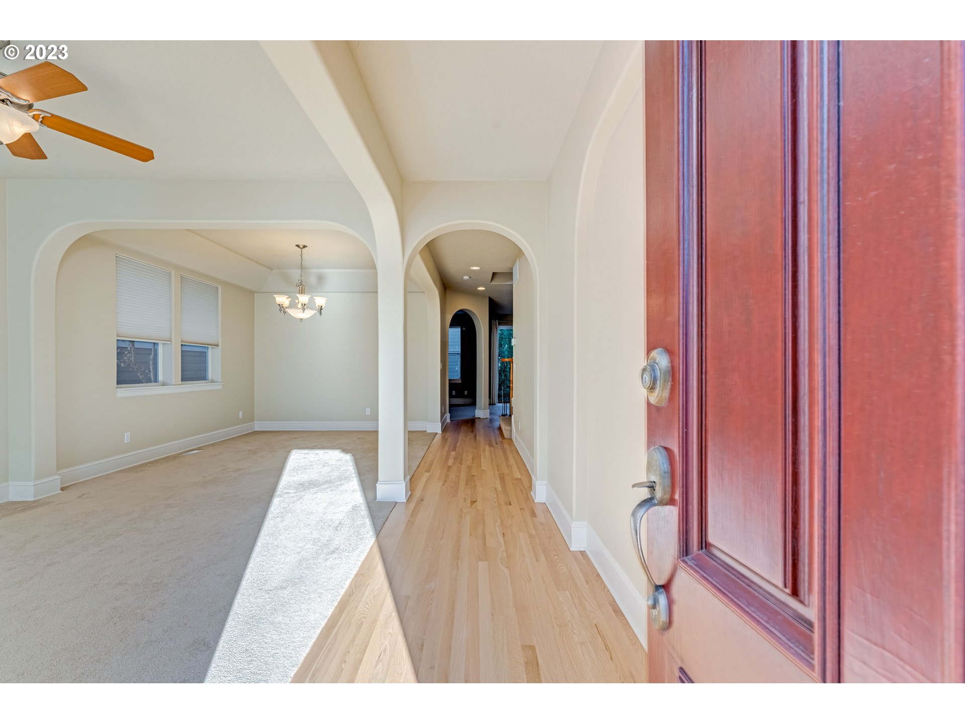 12581 Northwest Forest Spring Lane Portland, OR 97229 - Photo 4 of 48 a view of a hallway view with wooden floor and staircase
