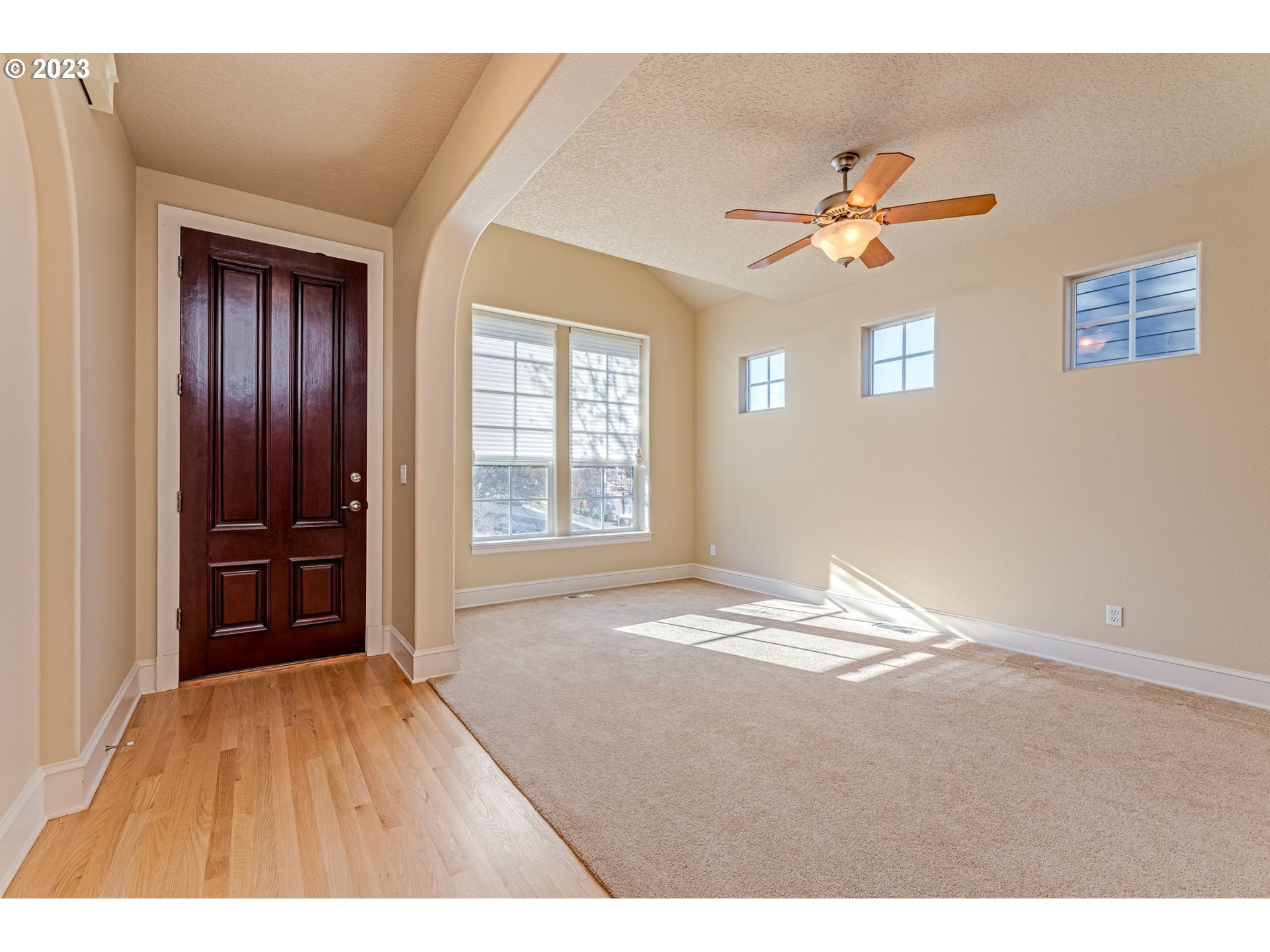 12581 Northwest Forest Spring Lane Portland, OR 97229 - Photo 5 of 48 a view of empty room with windows and ceiling fan