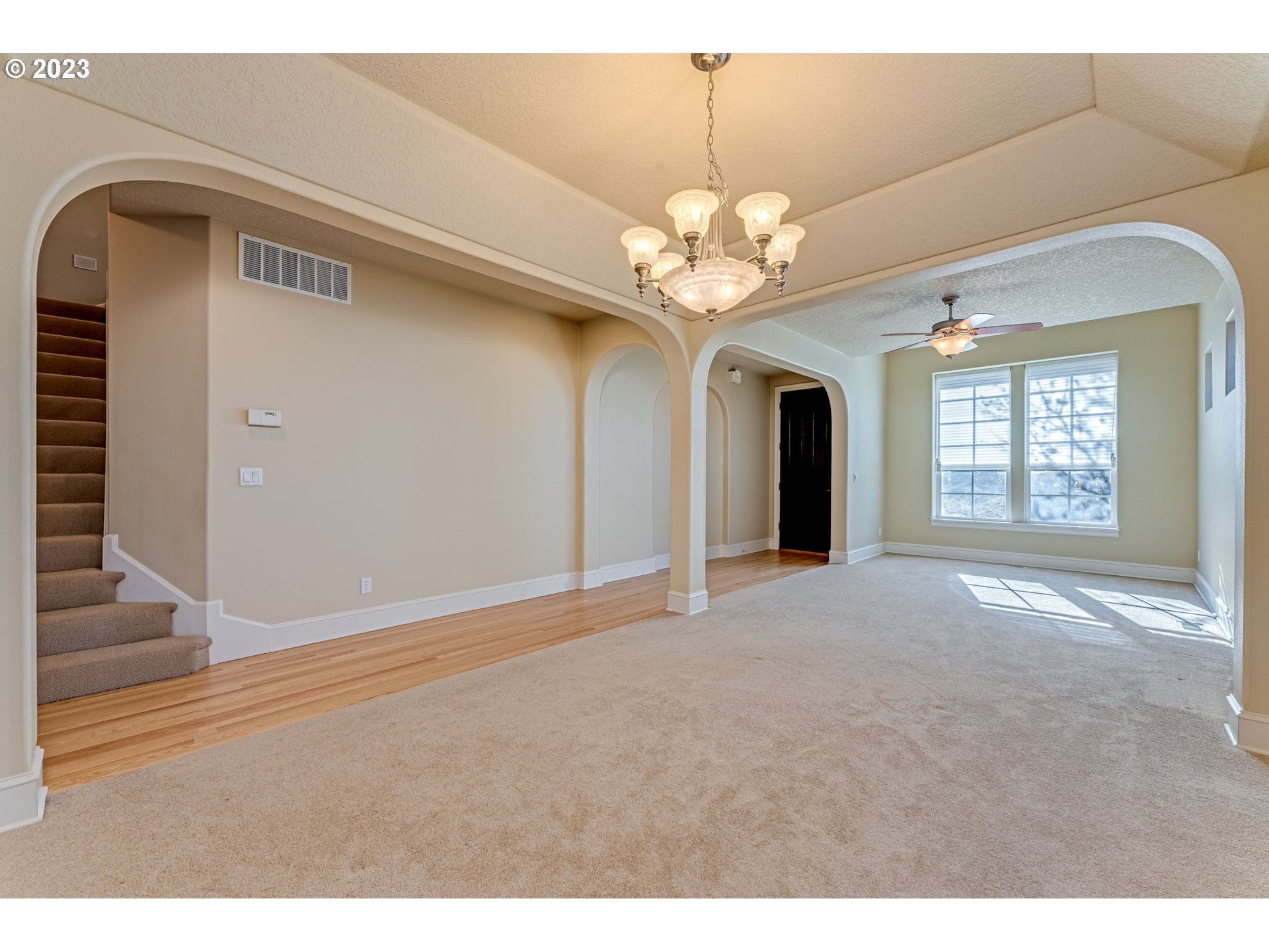 12581 Northwest Forest Spring Lane Portland, OR 97229 - Photo 9 of 48 a view of a livingroom with a chandelier fan and windows