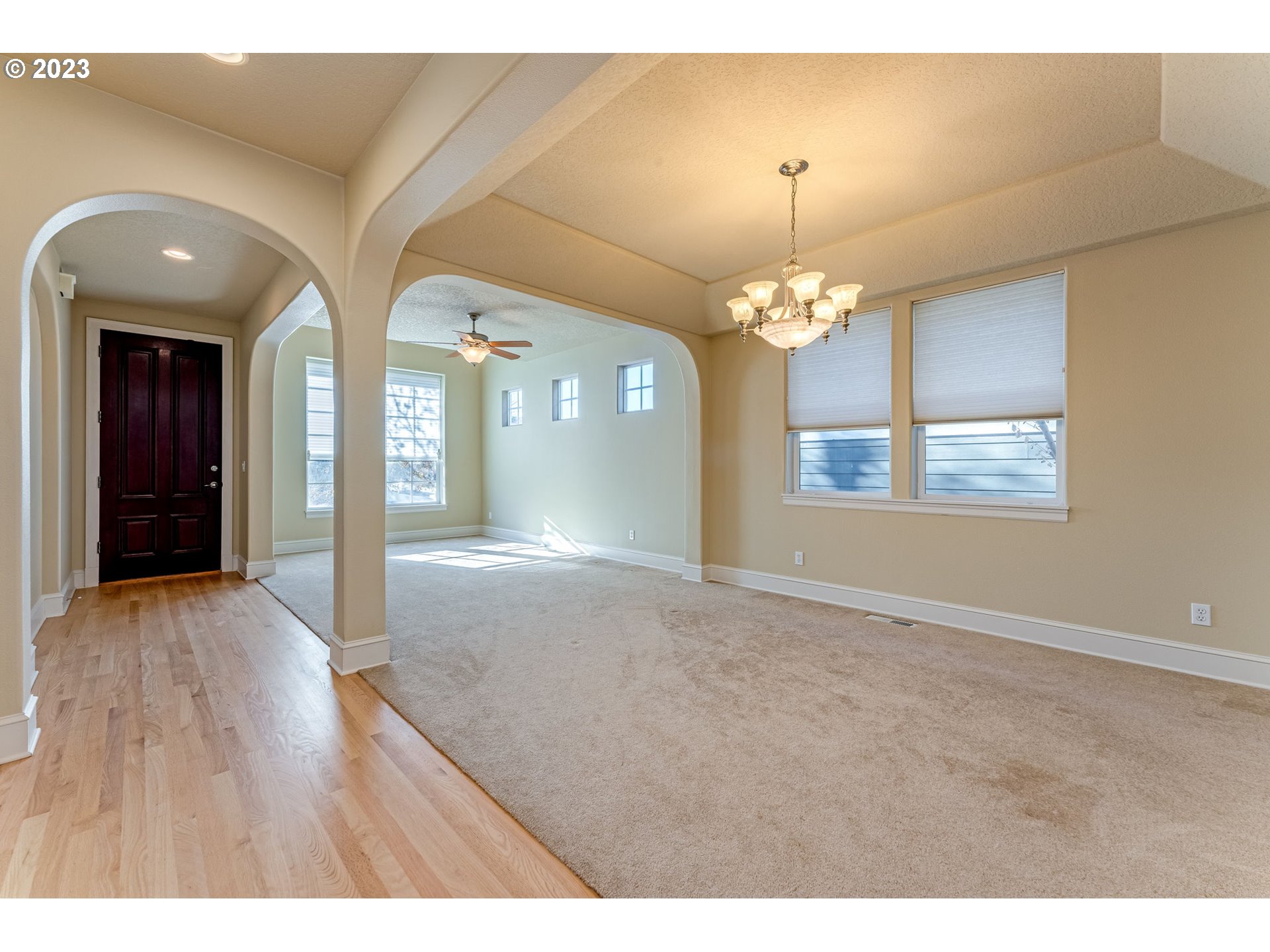 12581 Northwest Forest Spring Lane Portland, OR 97229 - Photo 10 of 48 a view of a hallway with windows and chandelier