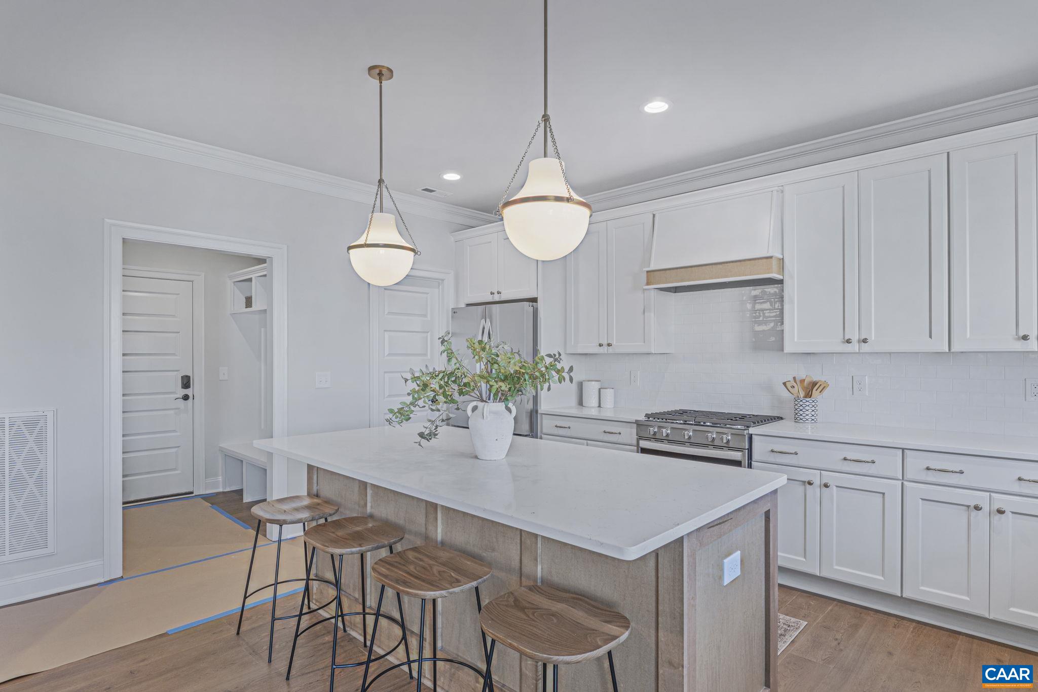 115226 Riparian Court Charlottesville, VA 22911 - Photo 17 of 49 a kitchen with a table and chairs in it