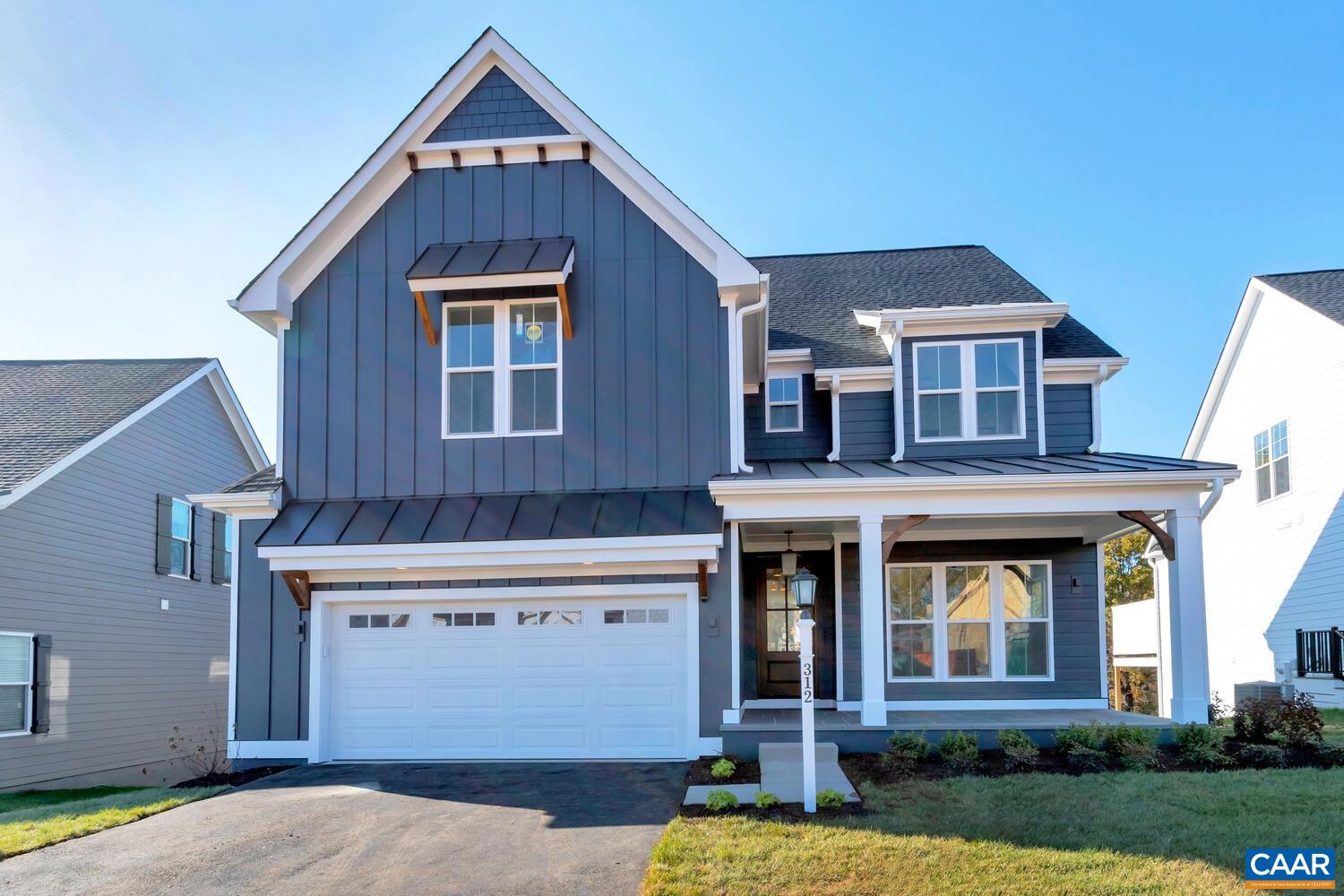 115226 Riparian Court Charlottesville, VA 22911 - Photo 2 of 49 a front view of a house with garden