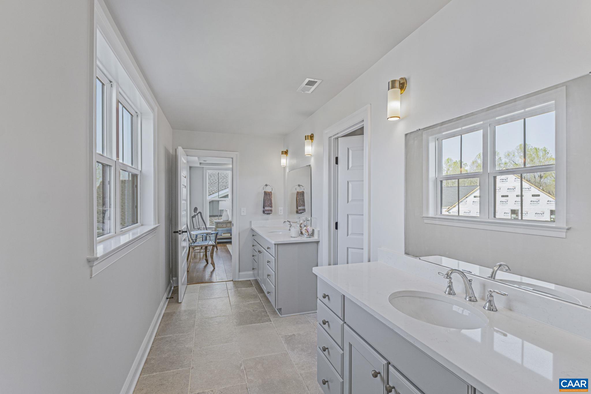 115226 Riparian Court Charlottesville, VA 22911 - Photo 26 of 49 a spacious bathroom with a double vanity sink a mirror a shower and a bathtub