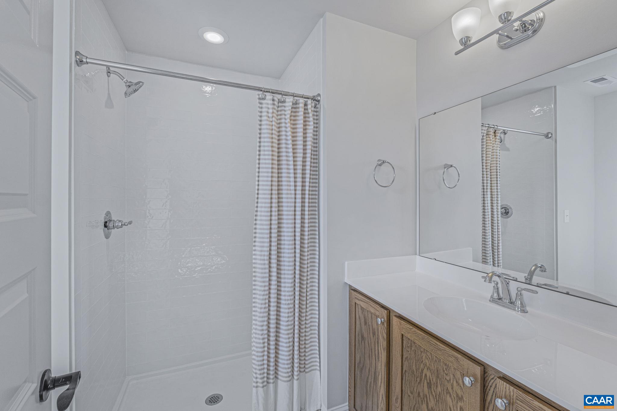 115226 Riparian Court Charlottesville, VA 22911 - Photo 32 of 49 a bathroom with a shower and a sink