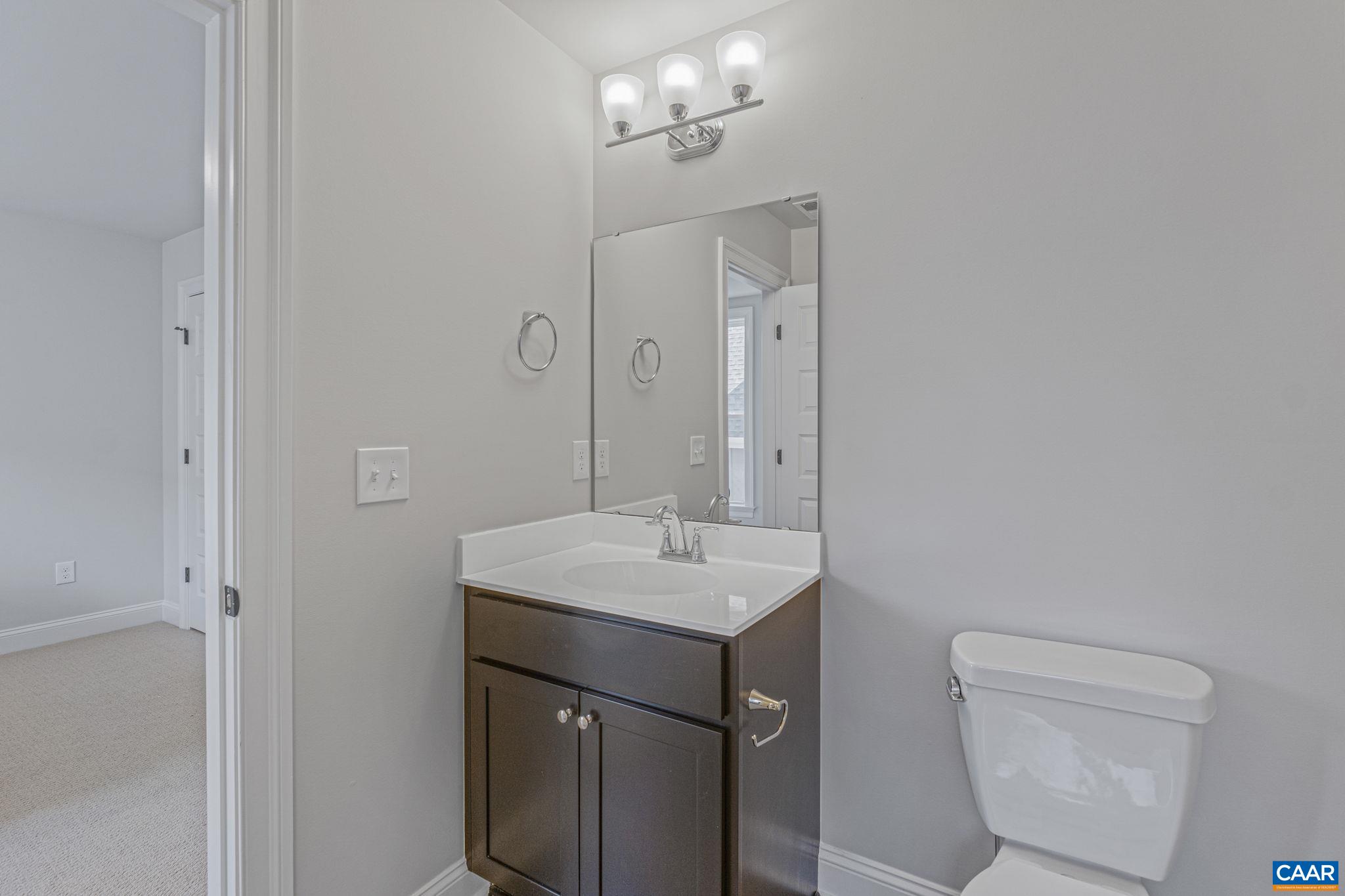 115226 Riparian Court Charlottesville, VA 22911 - Photo 37 of 49 a bathroom with a toilet sink and mirror