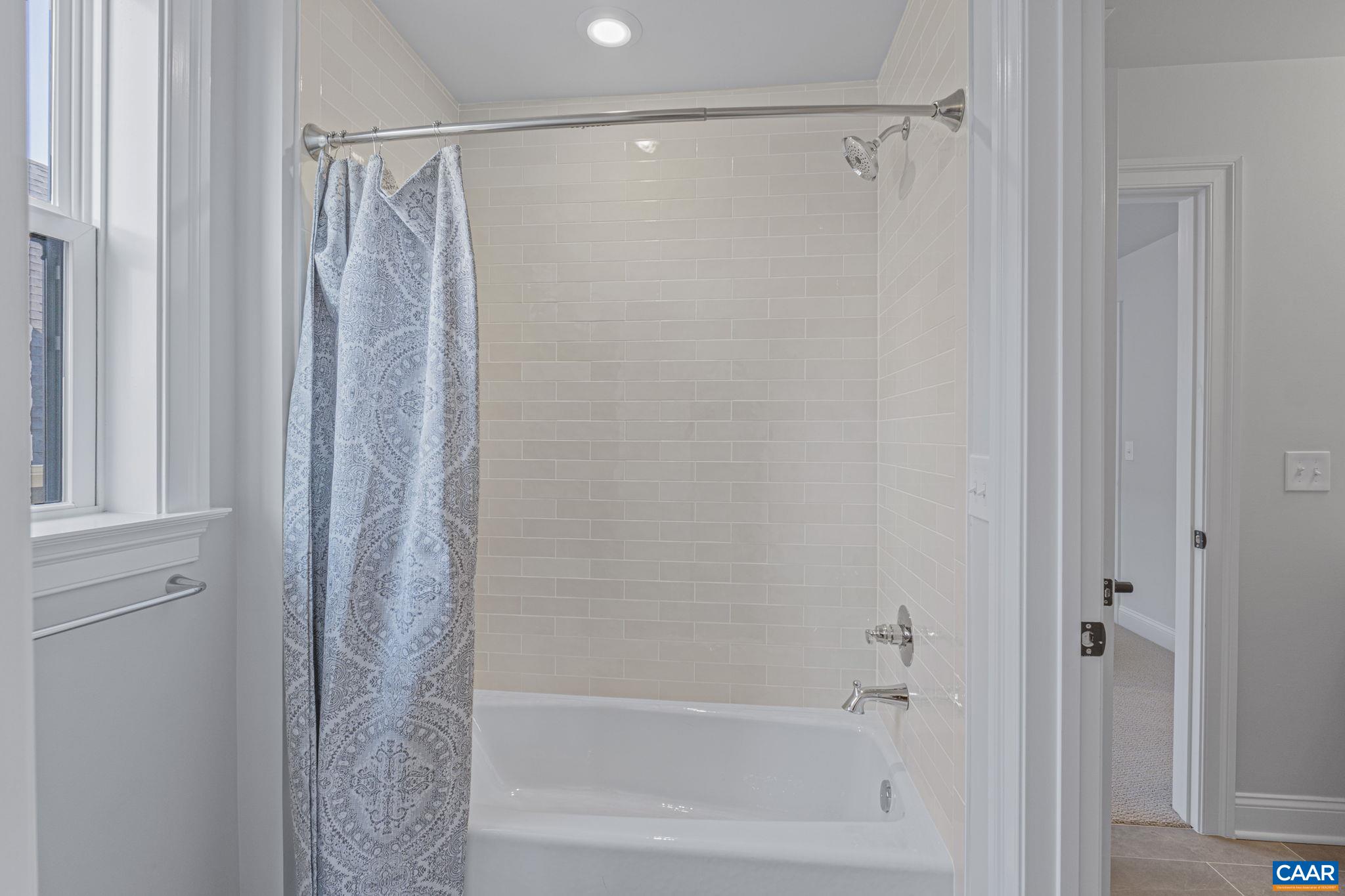 115226 Riparian Court Charlottesville, VA 22911 - Photo 38 of 49 a bathroom with a shower and a bath tub