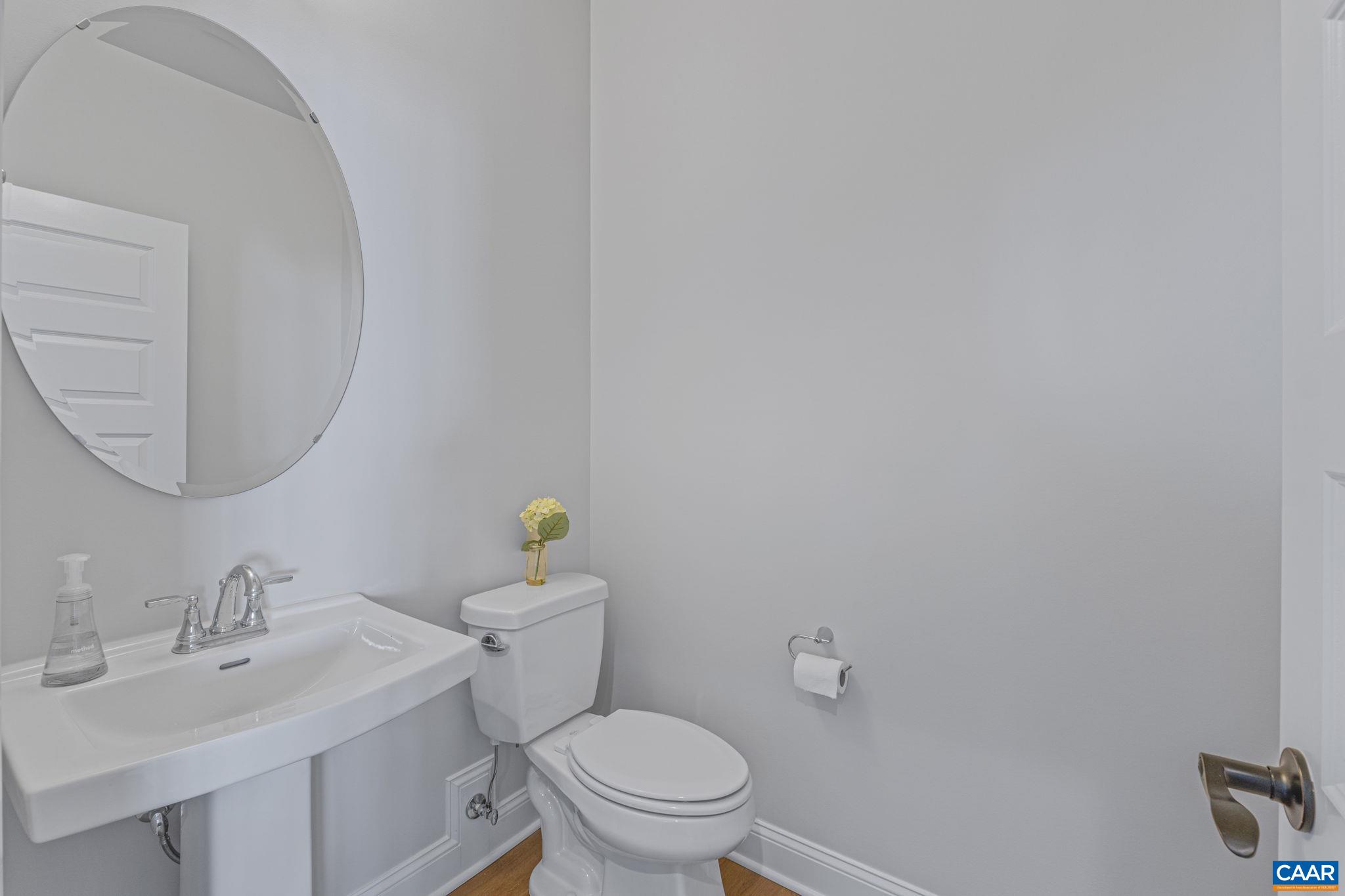 115226 Riparian Court Charlottesville, VA 22911 - Photo 9 of 49 a bathroom with a sink mirror and toilet