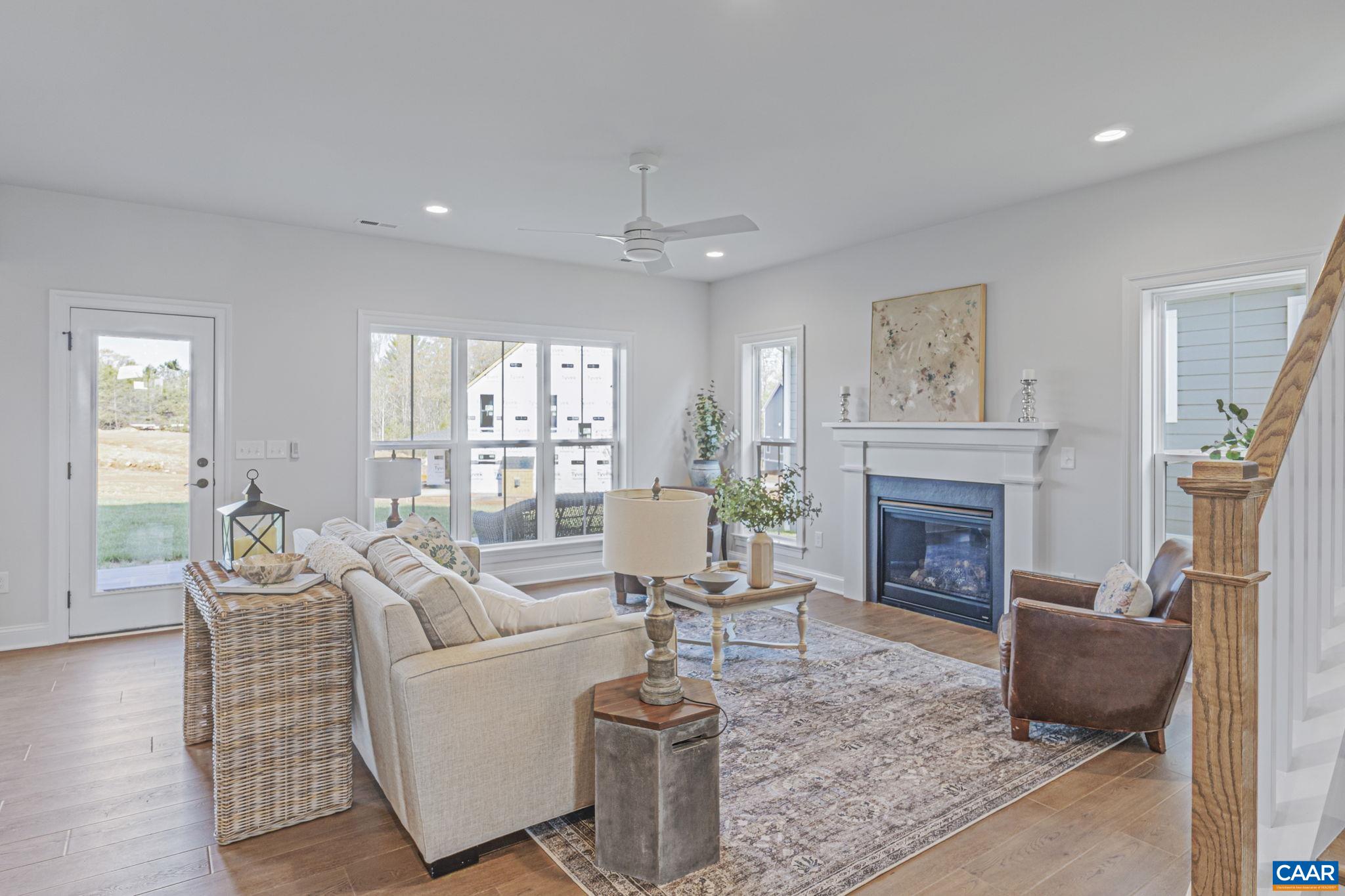 115226 Riparian Court Charlottesville, VA 22911 - Photo 10 of 49 a living room with furniture a large window and a fireplace