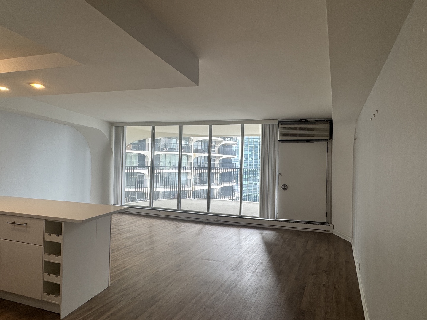 300 North State Street, Unit 4725 Chicago, IL 60654 - Photo 2 of 19 a view of an empty room with wooden floor and a window