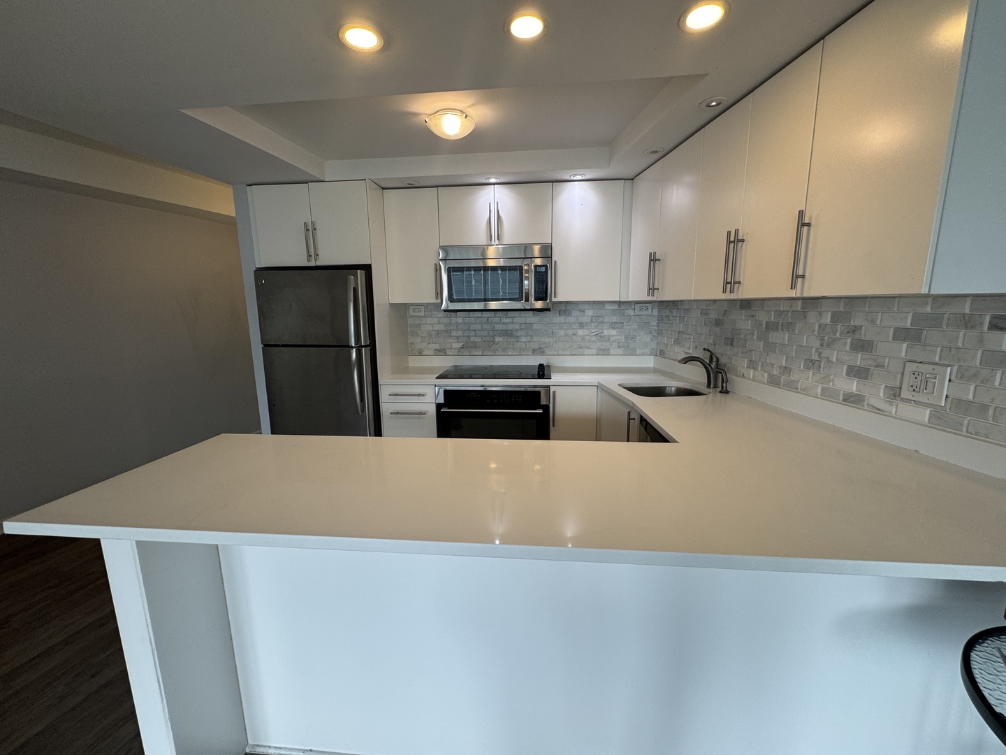 300 North State Street, Unit 4725 Chicago, IL 60654 - Photo 5 of 19 a large kitchen with stainless steel appliances a refrigerator a sink a stove and a refrigerator with wooden floor