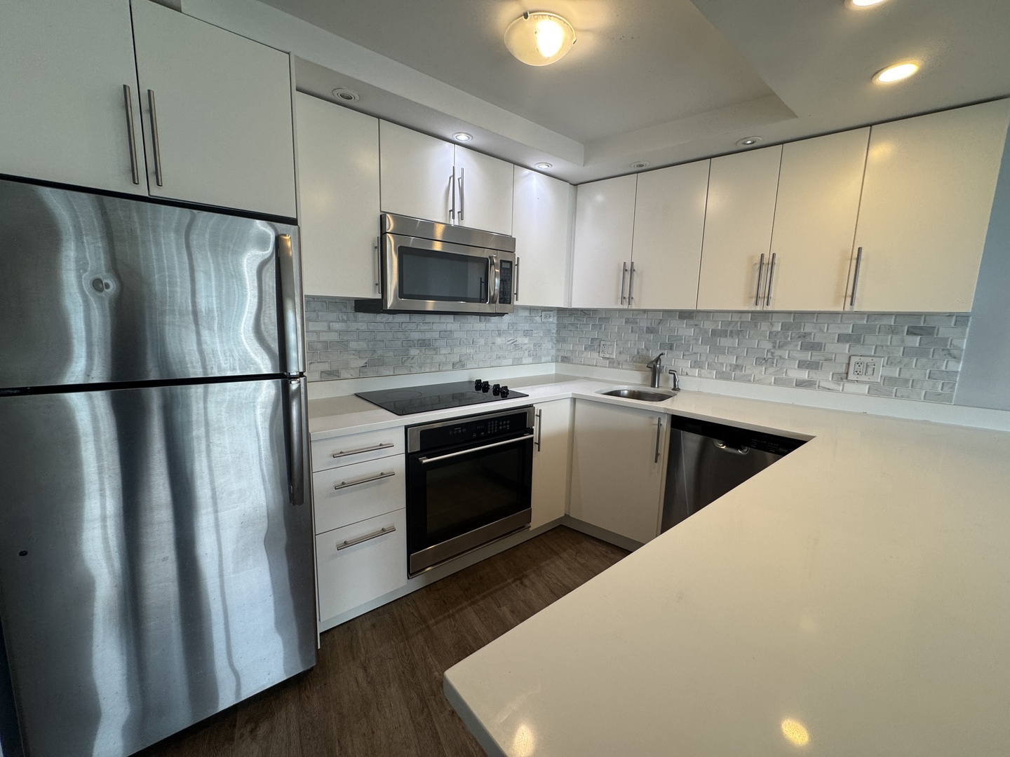 300 North State Street, Unit 4725 Chicago, IL 60654 - Photo 6 of 19 a kitchen with stainless steel appliances a sink stove and refrigerator
