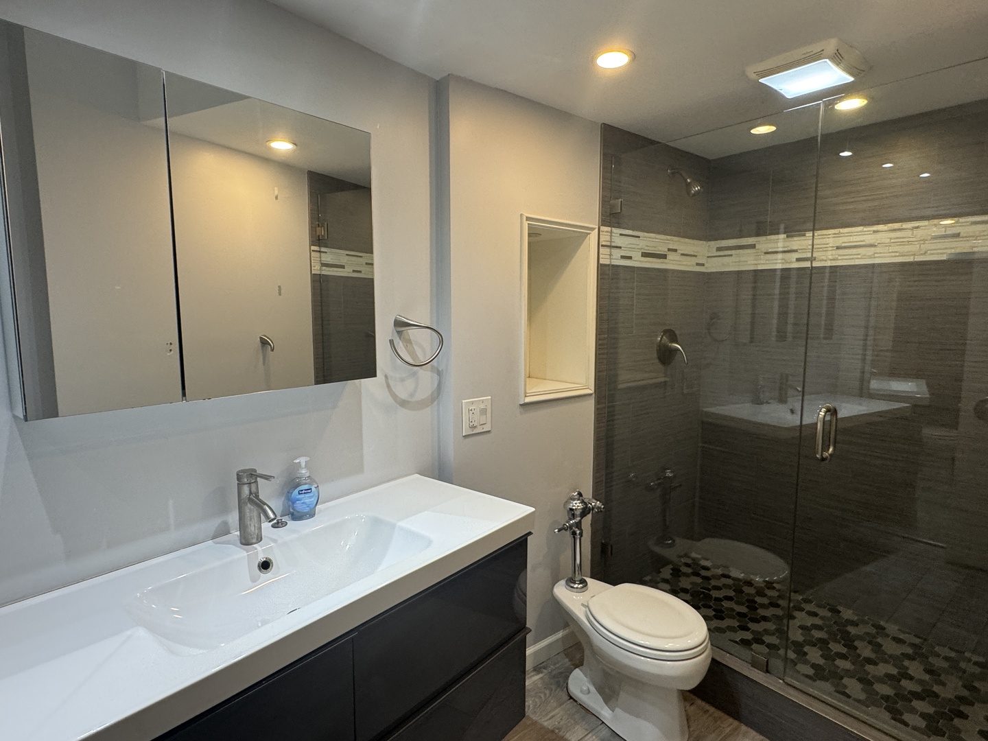 300 North State Street, Unit 4725 Chicago, IL 60654 - Photo 7 of 19 a bathroom with a sink toilet and shower