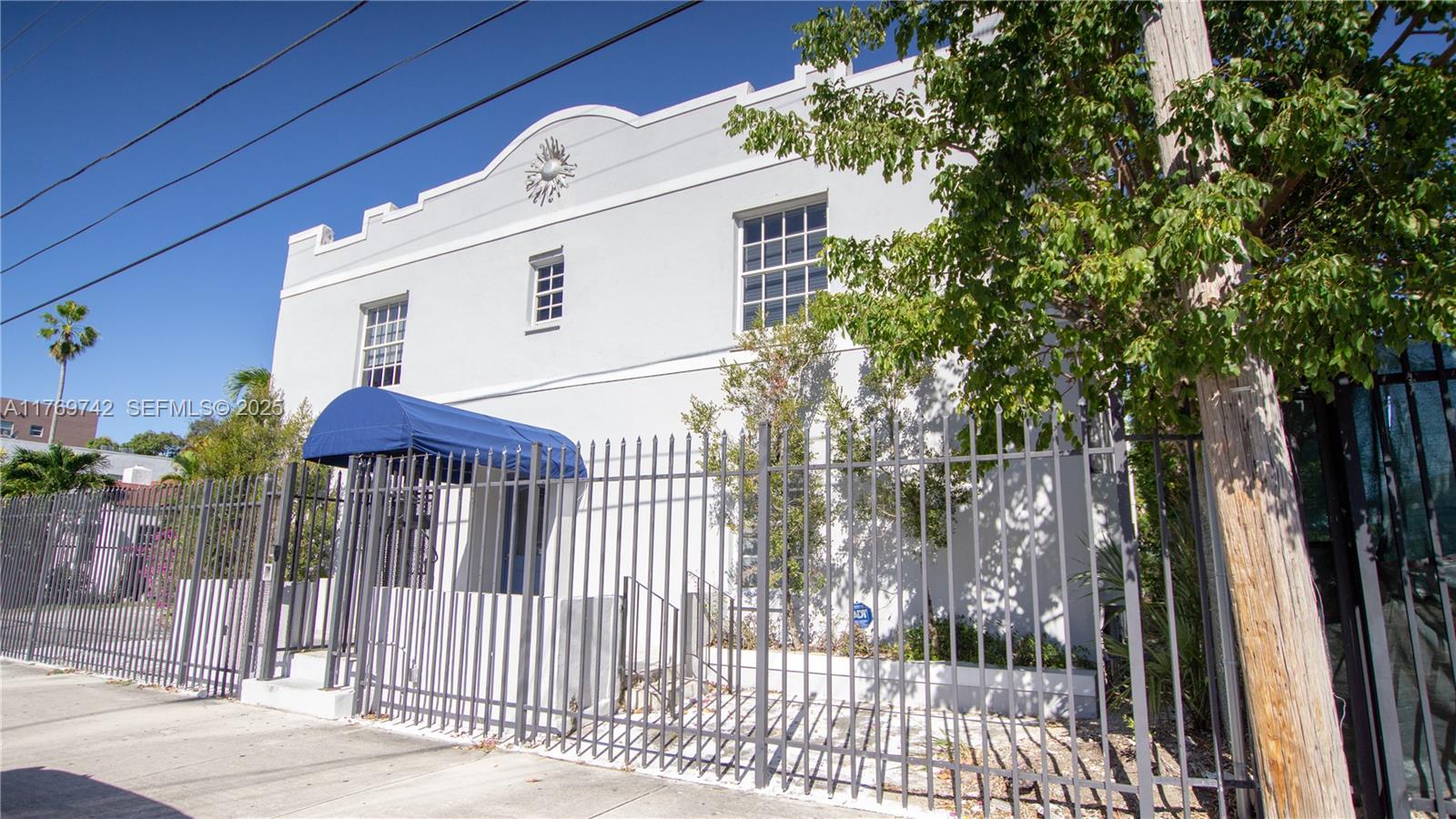 577 Northeast 62nd Street, Unit 2 Miami, FL 33138 - Photo 1 of 21 a front view of a house with a iron fence