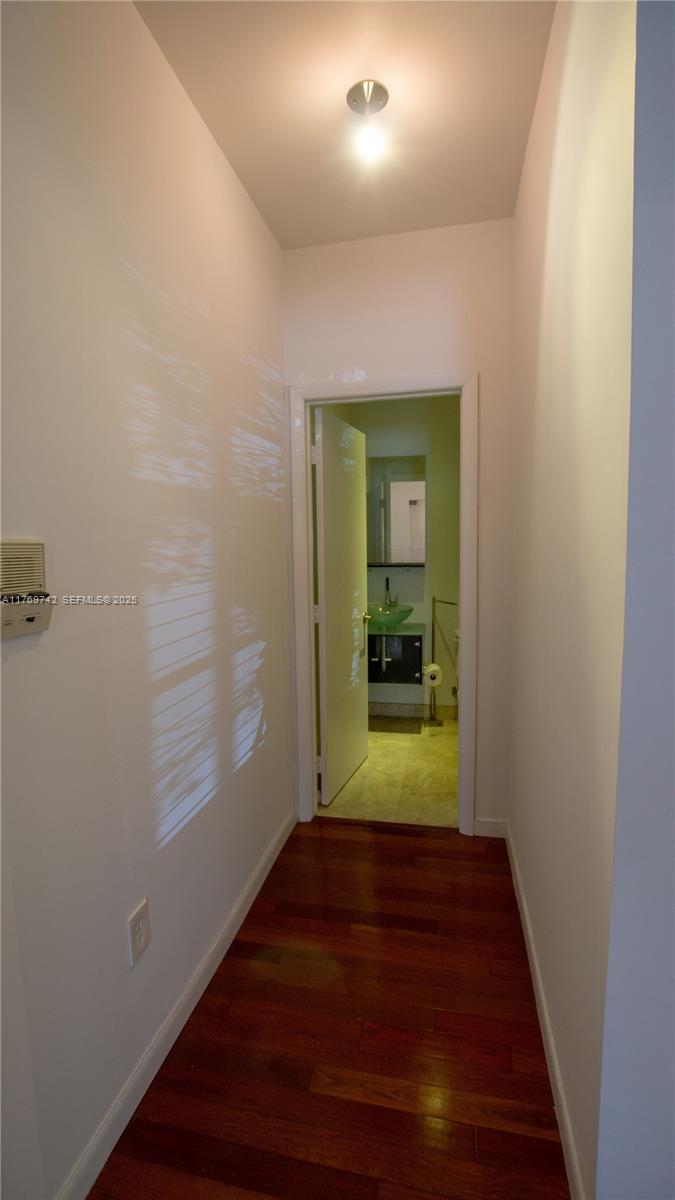 577 Northeast 62nd Street, Unit 2 Miami, FL 33138 - Photo 13 of 21 a view of a hallway with wooden floor and a bathroom
