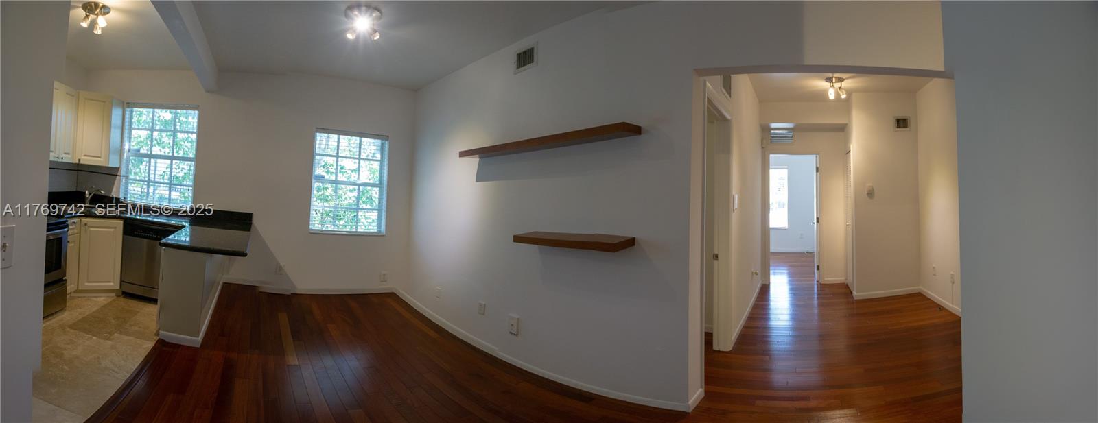 577 Northeast 62nd Street, Unit 2 Miami, FL 33138 - Photo 15 of 21 a view of a hallway with wooden floor and a living room