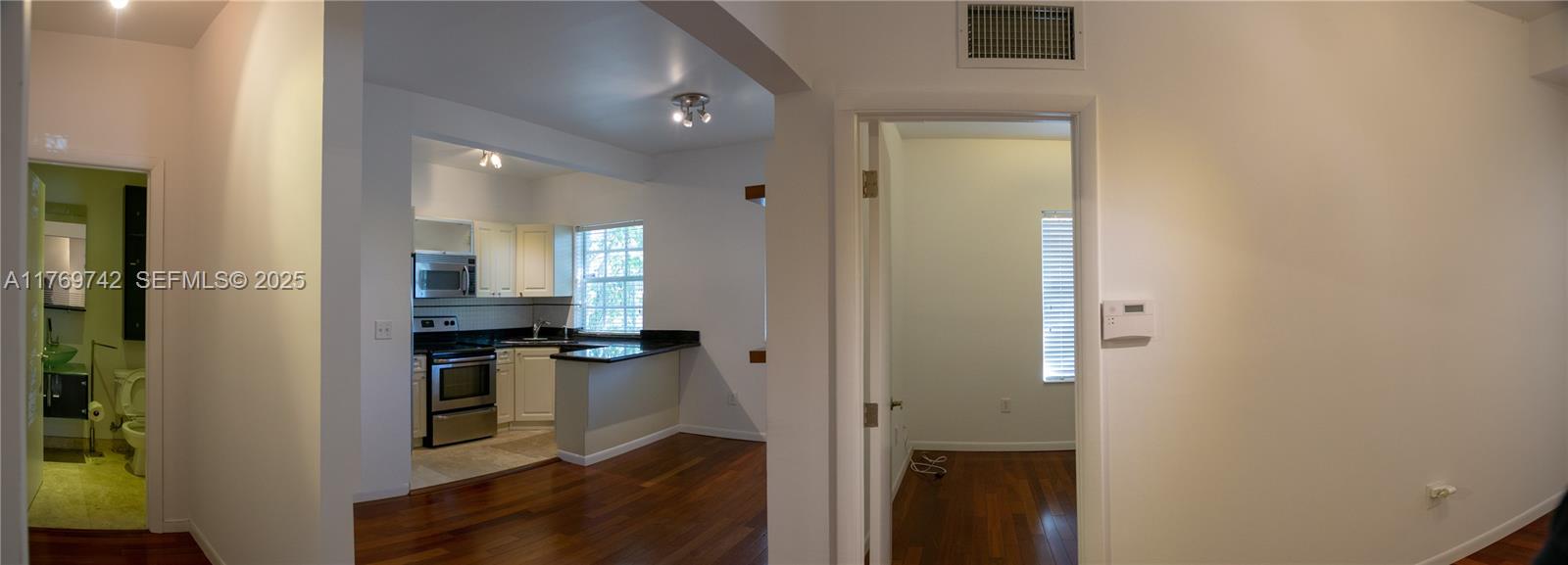 577 Northeast 62nd Street, Unit 2 Miami, FL 33138 - Photo 21 of 21 a kitchen with cabinets and stainless steel appliances
