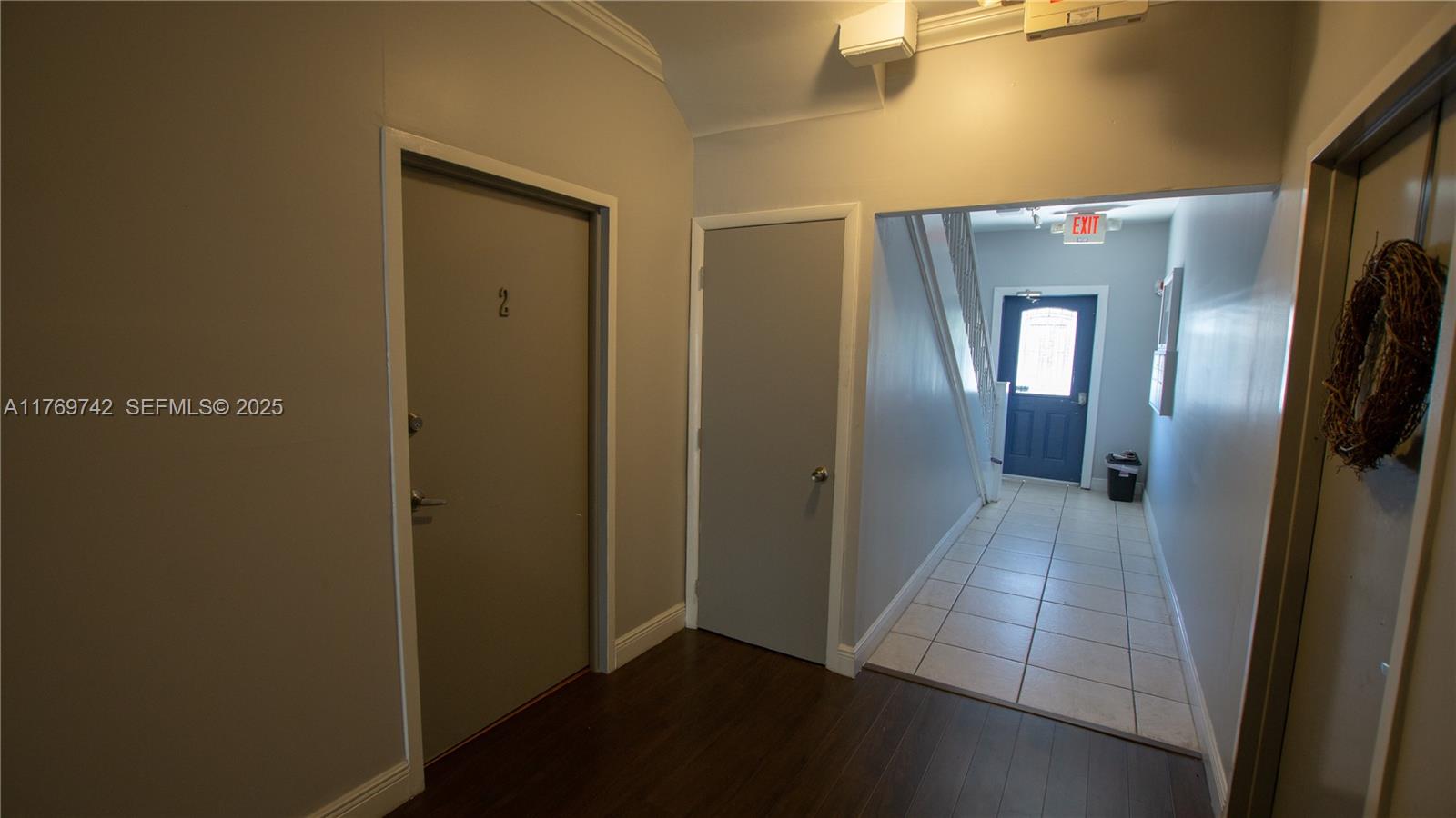 577 Northeast 62nd Street, Unit 2 Miami, FL 33138 - Photo 4 of 21 a view of a hallway with wooden shelves