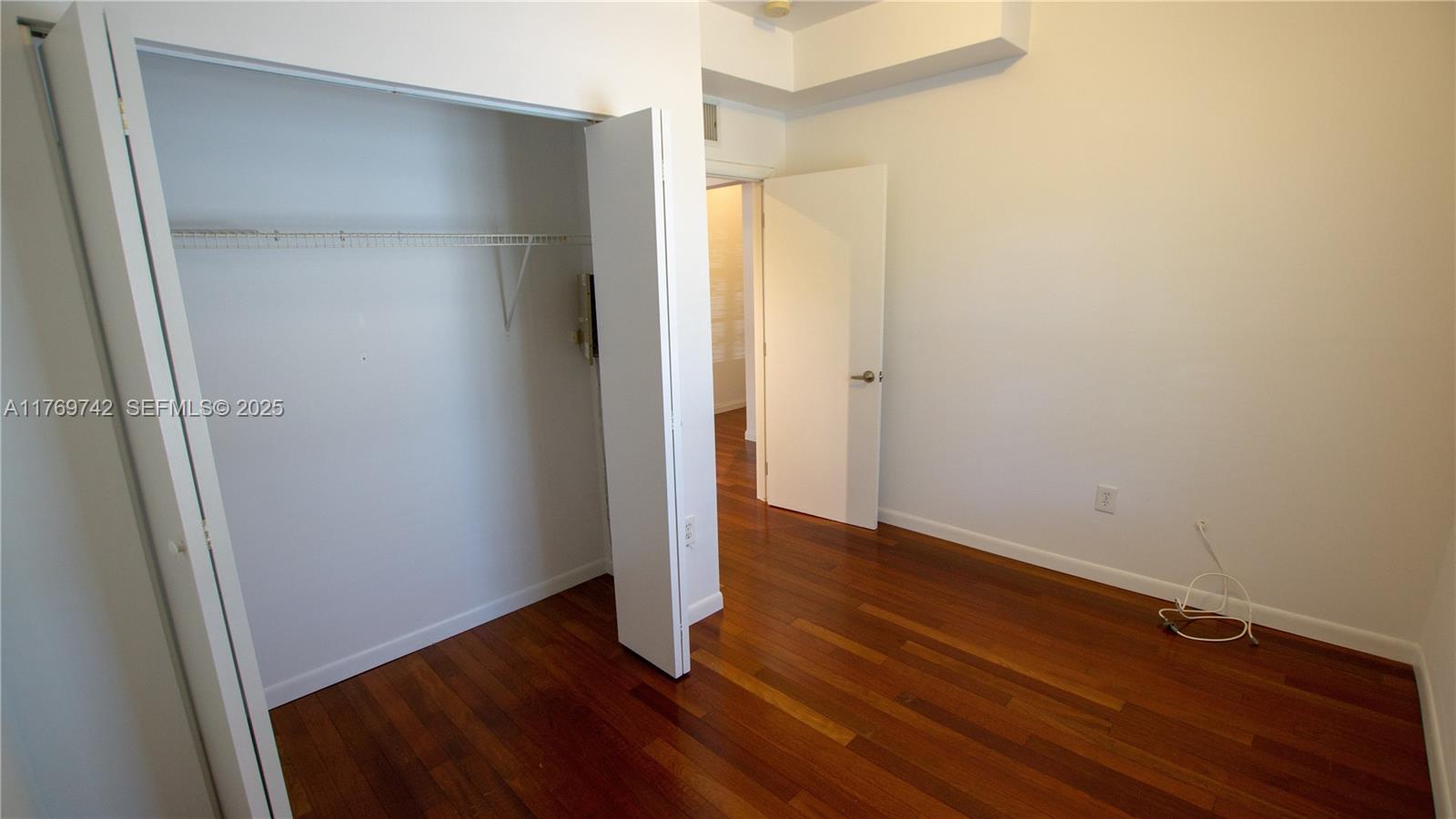 577 Northeast 62nd Street, Unit 2 Miami, FL 33138 - Photo 9 of 21 a view of an empty room with wooden floor