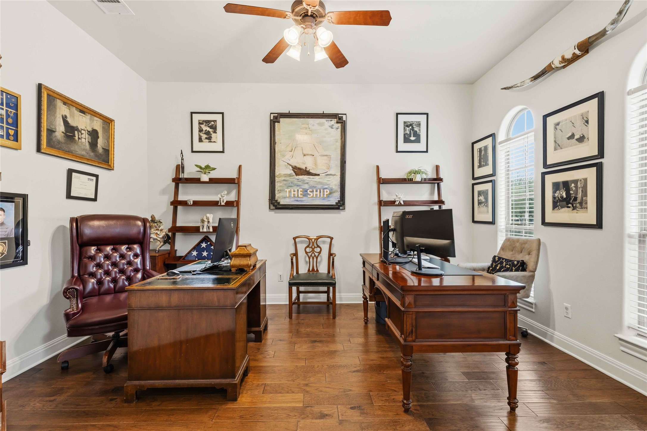 15200 Spillman Ranch Loop Austin, TX 78738 - Photo 14 of 40 Dedicated office space featuring hardwood floors, a ceiling fan, and arched windows providing natural light