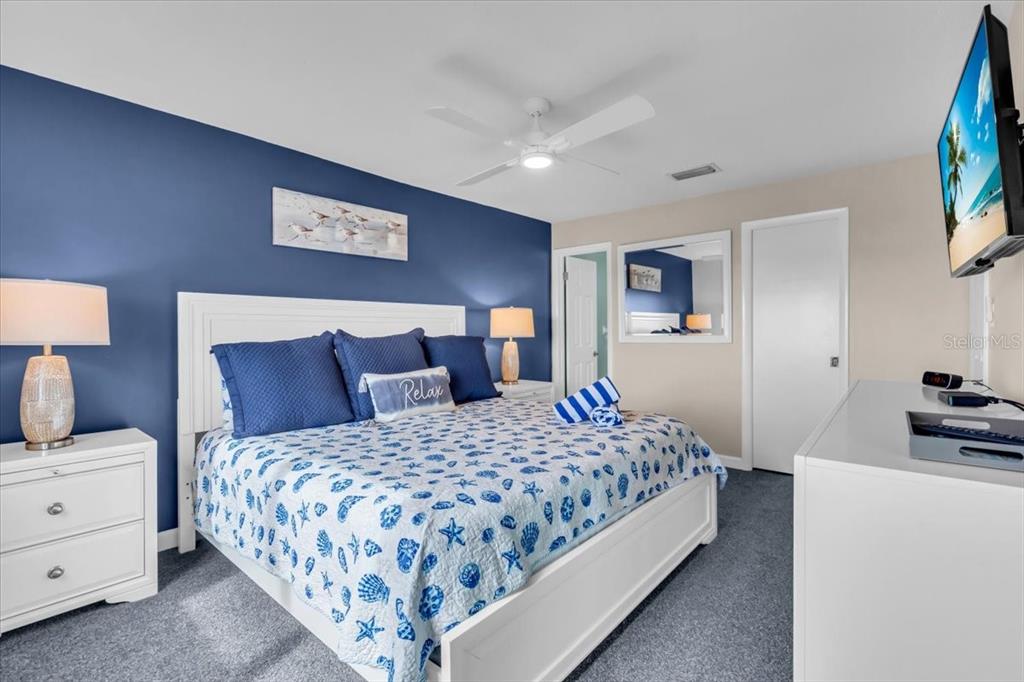 757 Beach Road, Unit 310 Sarasota, FL 34242 - Photo 13 of 31 a bedroom with a bed and a desk